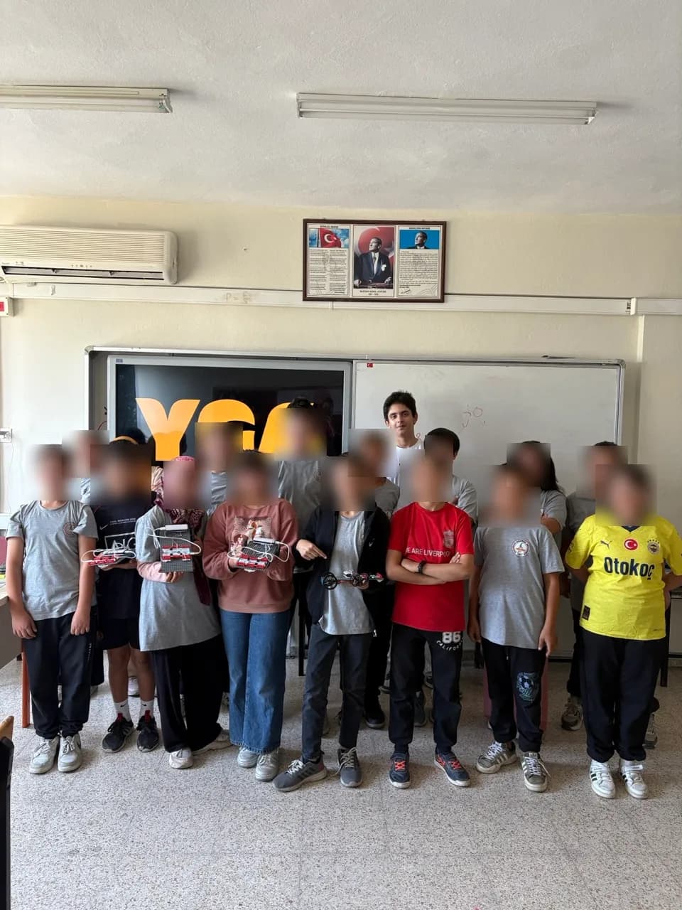 Children with the circuits they built, faces blurred