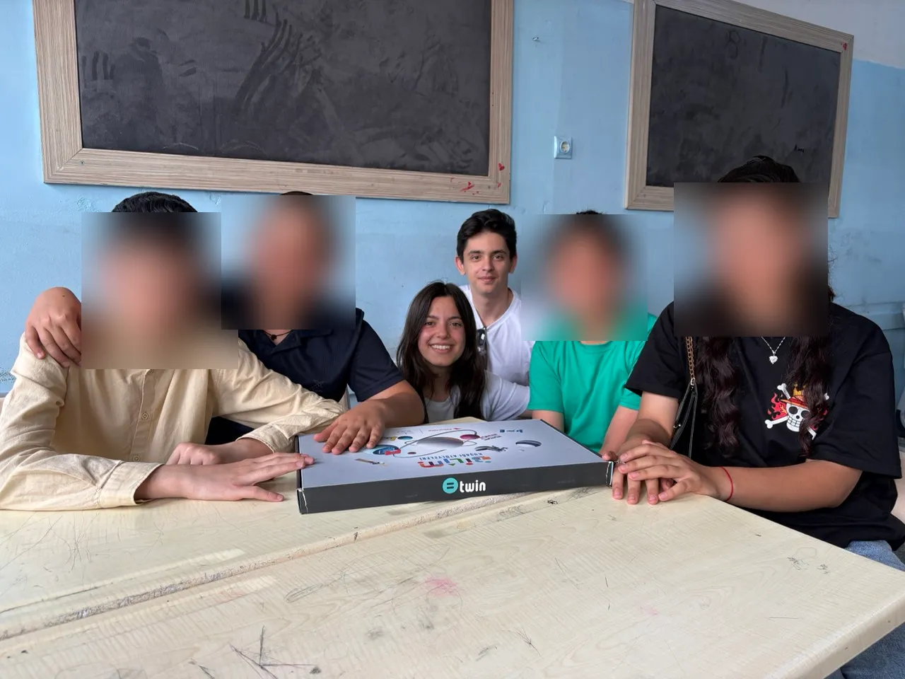 Children and volunteers around a Twin kit in Gaziantep, children's faces blurred