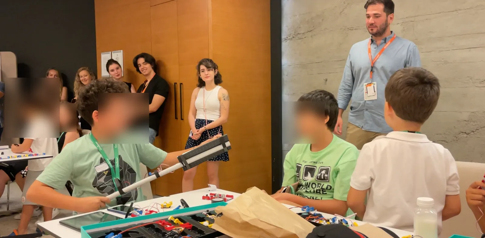 Children building with Twin kits at Unilever, faces blurred